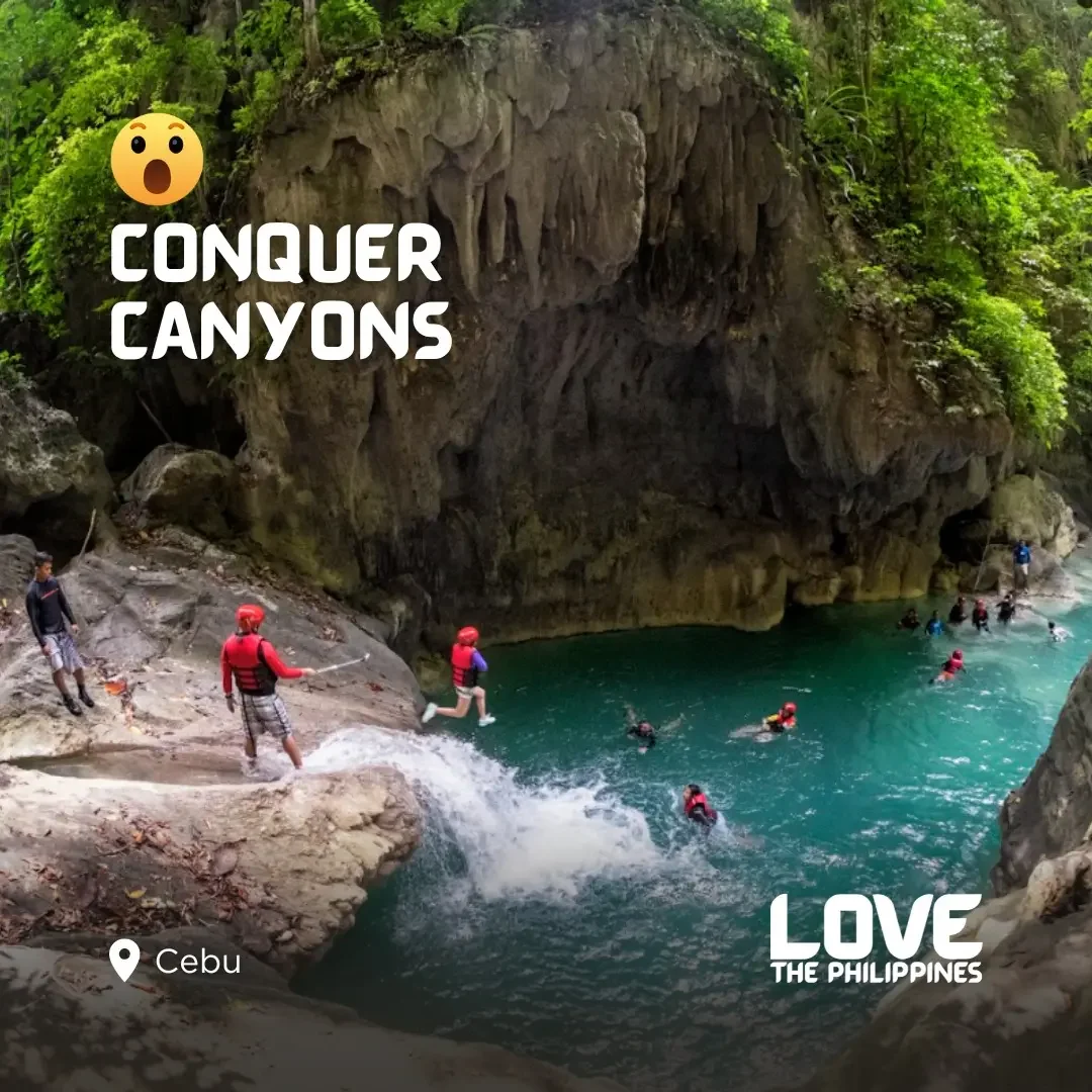 Traveler cliff-jumping into the turquoise pools of Kawasan Falls, Cebu